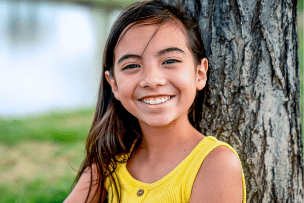 Happy young girl smiling outdoors
